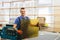 Glazier worker holding glass in workshop. Industry