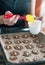 Glazing cookies on baking paper in a tray