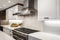 gleaming stainless steel range hood and sleek countertops in modern white kitchen