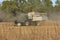 Gleaner Combine cutting a crop of soy beans in a farm field in Kansas.