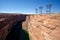 Glen Canyon and Colorado river below the dam with lattice crosses and high voltage power cables