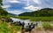 Glencar Lough landscape with many colorful small wooden fishing boats on the lakeside