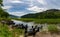 Glencar Lough landscape with many colorful small wooden fishing boats on the lakeside