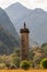 The Glenfinnan Monument, a tall column, topped by a statue of s kilted Highlander, in Glenfinnan, Scotland