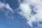 Glider climbing under scattered white clouds,  New Zealand