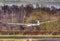 Glider landing across hedgerow