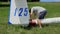 Glider pilot changing back tail wheel on airplane before flight