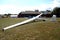 Glider plane standing on grass airport runway, at Pociunu airport, Lithuania