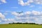 Glider, sailplane in landing, with blue clouds sky