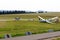 Glider sailplane towed behind a powered aircraft during takeoff on Wasserkuppe airfield