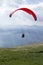 Glider takes off over the lake and the mountains