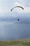 Glider takes off over the lake and the mountains