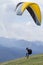 Glider takes off over the lake and the mountains