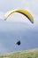 Glider takes off over the lake and the mountains