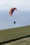 Glider takes off over the lake and the mountains