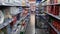 Gliding shot of supermarket interior with large assortment of foodstuff, drinks, bodycare and complementary products on