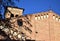 Glimpse of the side and top of the bell tower of the church of the hermits, outlined by the blue sky and illuminated by the sun of