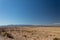 Glimpse of snow on a mountain ridge, New Mexico desert under brilliant blue sky