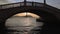Glimpse under the vault of a bridge of San Giorgio isle at sunset, Venice