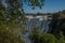 Glimpse of Victoria Falls framed by branches