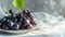 Glistening Grapes: Sunlit on a Delicate White Plate