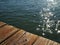 Glistening water beneath old wooden dock