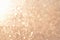Glitter abstract background with unfocused soft golden light.