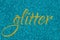 Glitter lettering word gold on cyan blue sparkle texture. Shiny background