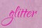Glitter lettering word neon pink on light pink ballet slipper sparkle texture. Shiny background