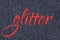 Glitter lettering word red grenadine on gray midnight blue black sparkle texture. Shiny background