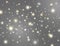 Glitter lights effect. Magic dust particles. Bright golden and white sparkles on grey background. Shining stars