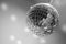 Glittering disco ball hanging upside down from the ceiling, illuminating the room in grayscale