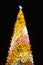 Glittering Glowing Sparkling Gold defocused Night Light bokeh Illumination background with decorated Christmas Tree. Special