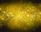 Glittering stars on a gold bokeh background. Night sky with stars background / texture