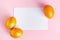 Glittery golden Easter eggs and blank greeting card on pink background