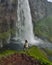 Gljufrafoss Gljufrabui waterfall in gorge of mountains. Tourist attraction Iceland near falls of Seljalandsfoss. Man