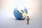 Global Business and Planning concept. Businessman miniature figure standing on ground and looking to mini world ball on white