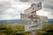 a global crisis text on wooden signpost outdoors in nature.