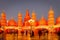 Global Village amusement park at night with red and orange illuminated arabic style towers and domes.