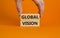 Global vision symbol. Wooden blocks with words `Global vision` on beautiful orange background. Businessman hand. Business and