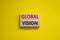 Global vision symbol. Wooden blocks with words `Global vision` on beautiful yellow background. Business and global vision concep