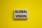 Global vision symbol. Wooden blocks with words `Global vision` on beautiful yellow background. Business and global vision concep