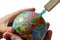 Globe in children`s hands. A syringe is plugged into Kazakhstan. Isolated. The concept of global disease and treatment of the