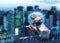 The globe Earth in the hand of businessman with the blurred evening cityscape.