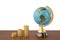 Globe and gold coin stacks on wood board 3d illustration.