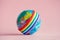 Globe with LGBT colorful rainbow ribbon on pink