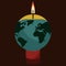 a globe and a lit candle to represent the campaign against climate change called earth hour