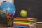 Globe, notebook stack and pencils. Schoolchild and student studies accessories.