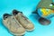 Globe and old worn sneakers in gray on a blue background