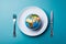 Globe on a plate for food on a blue background. Power, economy, politics, globalism, hunger, poverty and world food concept